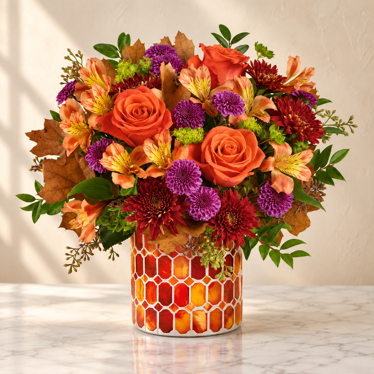 Orange roses, peach alstroemeria and purple mums in an amber stained-glass vase