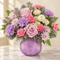 Light pink roses, lavender carnations and white mums in a lavender art-deco vase