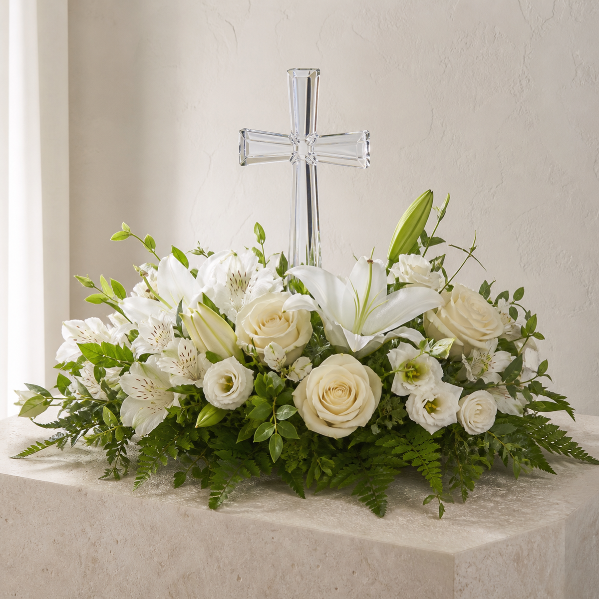 Keepsake crystal cross surrounded by white roses and lilies
