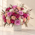 Lavender, mauve, magenta and peach roses with white hydrangea in a stone-finish cube