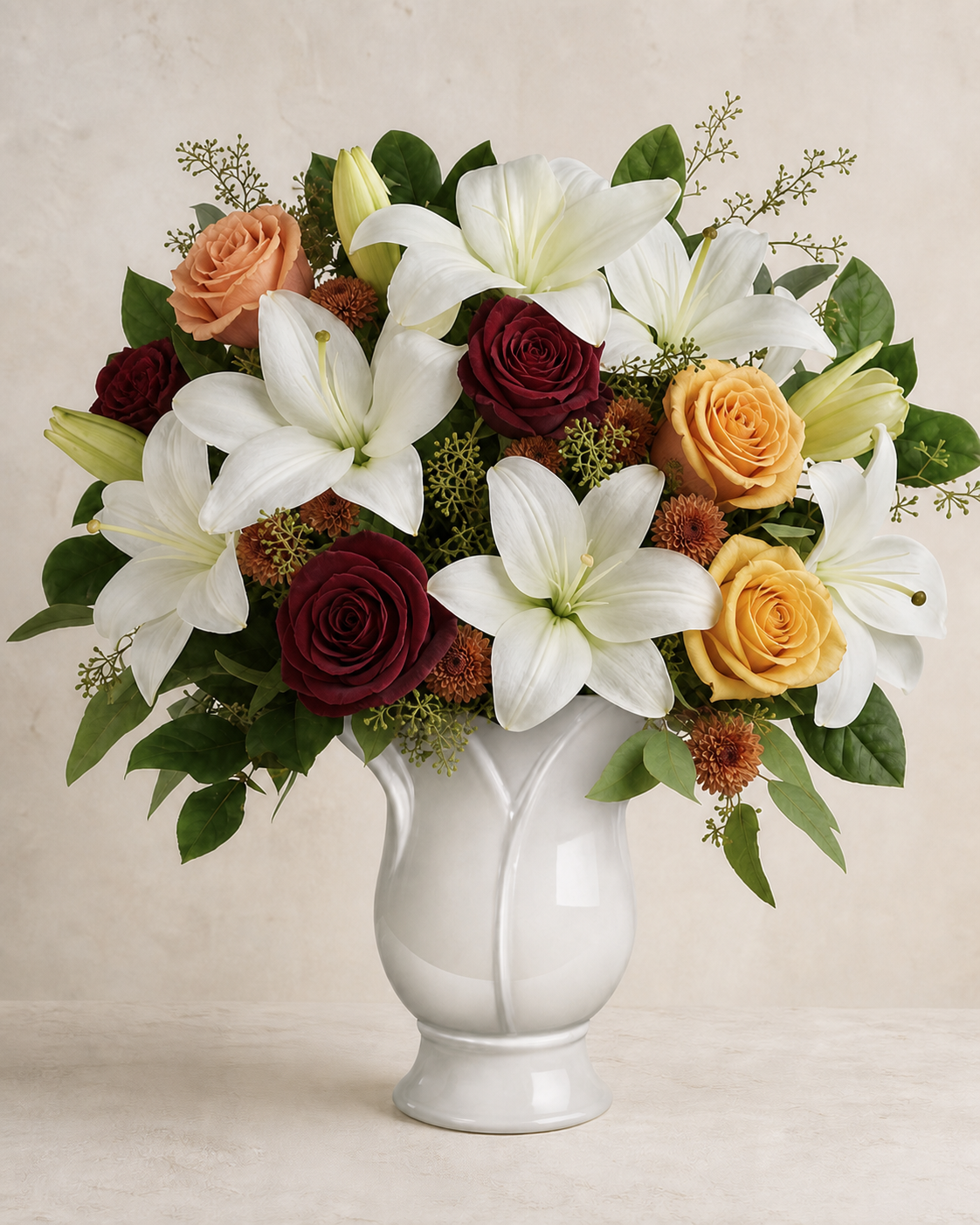 Autumn seasonal palette lily and rose service tribute in a white ceramic vase