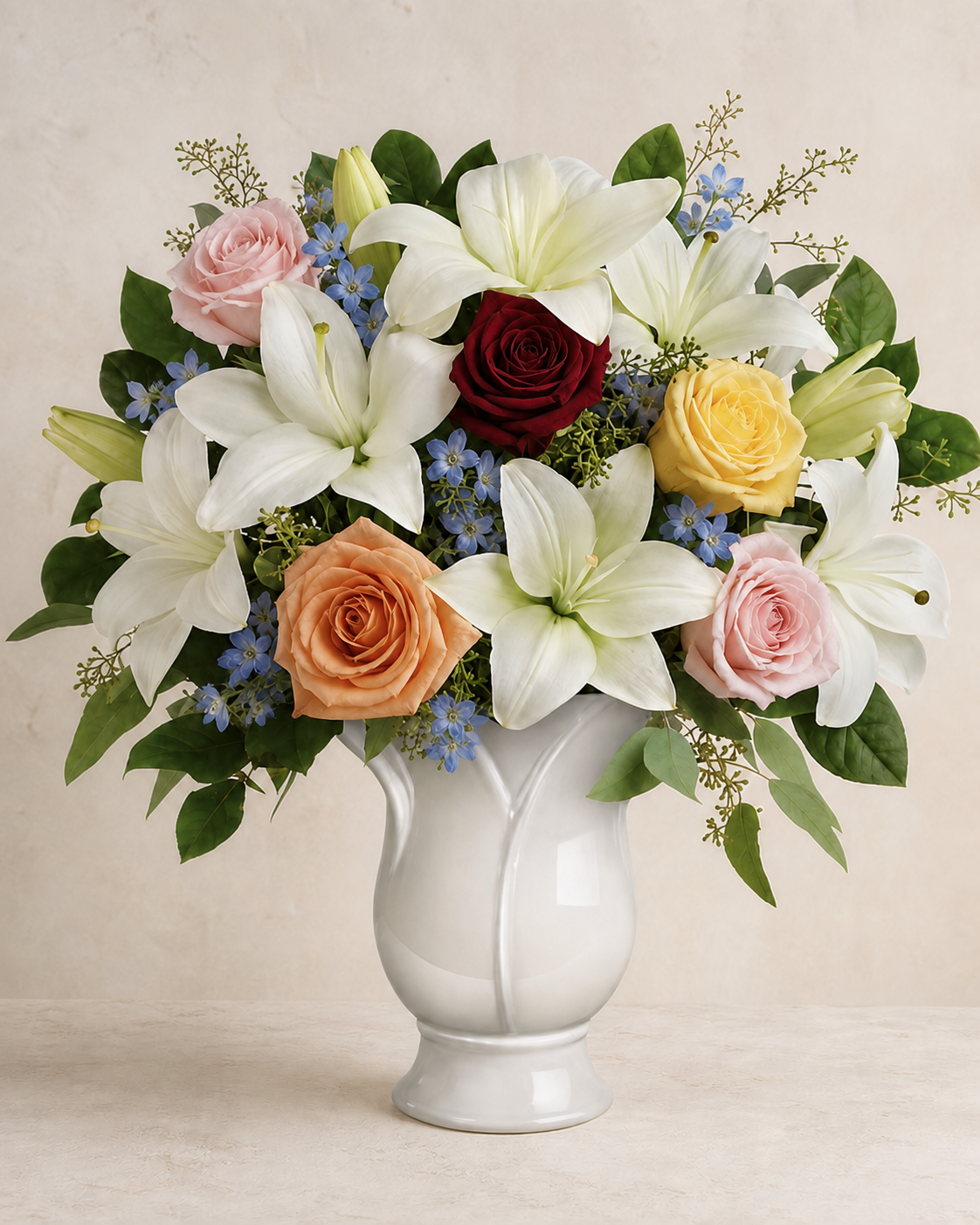 Mixed natural-color roses, blue accents and cream-white lilies in a ceramic vase