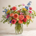 Mixed seasonal garden flowers in a clear glass vase