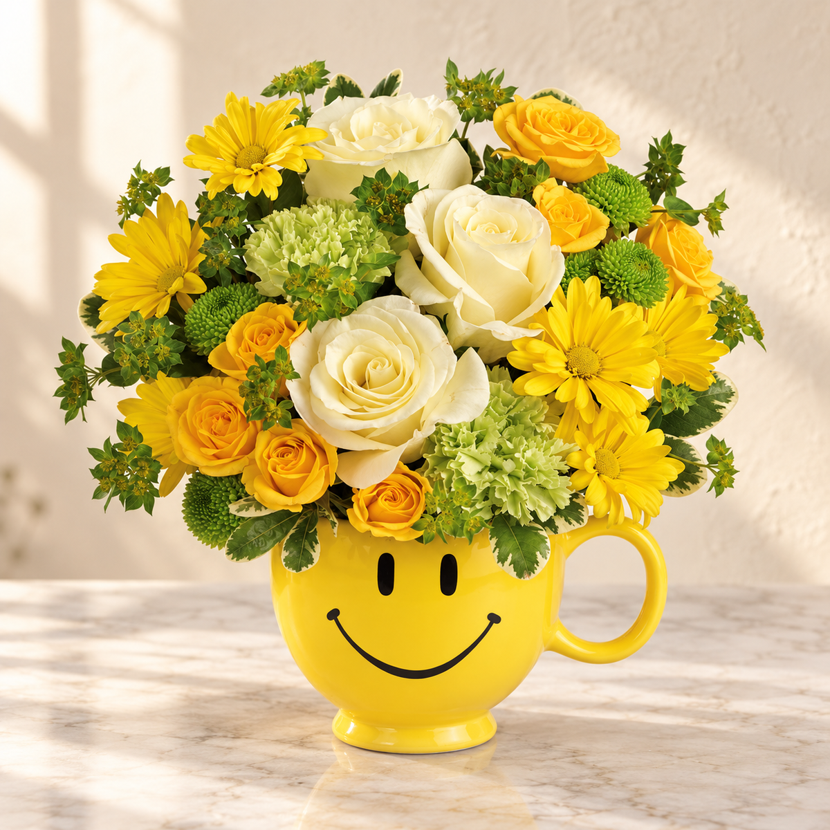 Cream and yellow roses with yellow daisies and green carnations in a yellow smiley-face mug